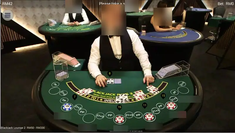 NTC33 live blackjack table Blackjack Lounge 2 with a dealer at a green seven-seat table, BLACKJACK PAYS 3 TO 2 and INSURANCE printed on the felt, PP and 21+3 circles at each seat, limit RM50 - RM200